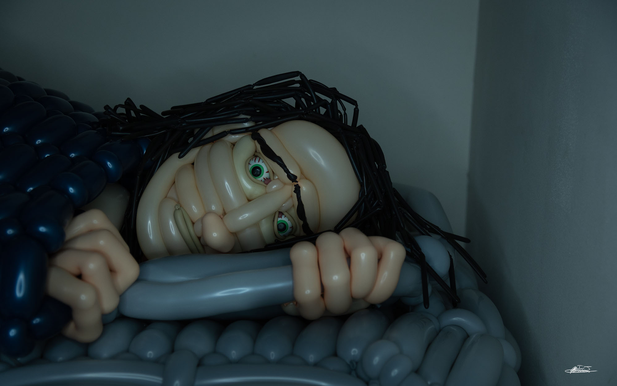 Sometimes Falling Asleep Feels Like Dying balloon sculpture of man in bed lying awake